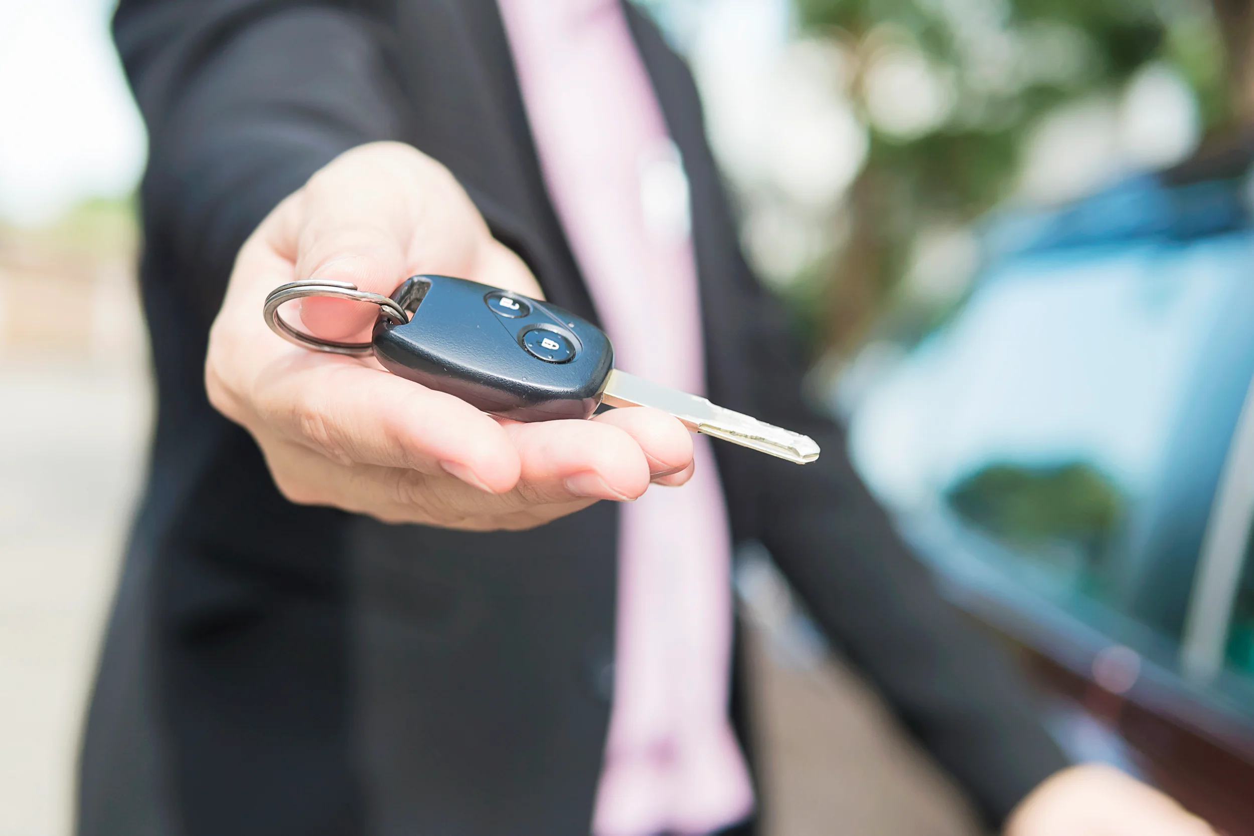 man is giving car key to somebody